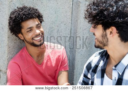 Happy African American Man Talking With Friend Outdoor In The City In The Summer