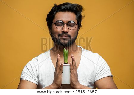 Sentimental Young Man Is Holding A Flower Pot In Hands. Hindoo Male Adores Flowers. Gardener With Fl