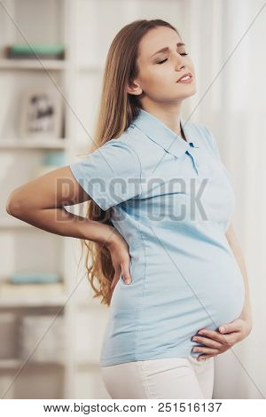 Young Pregnant Girl Suffering From Pain At Home. Maternity Concept. Caucasian Feel Ill. Expecting Ba