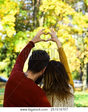 Man And Woman Turned Backwards On Autumn Trees Background. Girl And Bearded Guy Or Happy Lovers On A