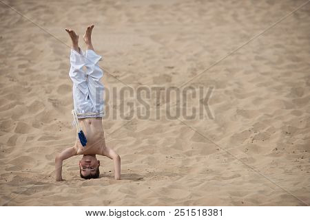 Boy Practicing Capoeira, Brazilian Martial Art That Combines Elements Of Dance, Acrobatics And Music