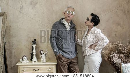 Happy Asian Senior Couple Casual Dress With Sunglasses In Vintage House