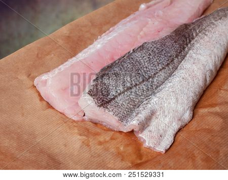 Two Raw Fillets Of Hake, Fish, On Brown Paper