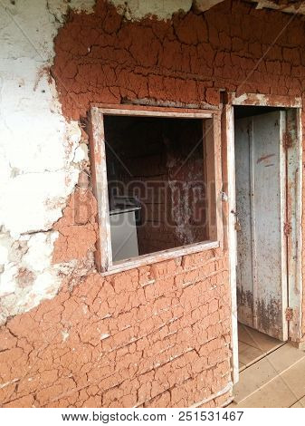 Traditional Bahareque (bareque) House In Colombia With Brown Bricks, Small Windows And White Door. B