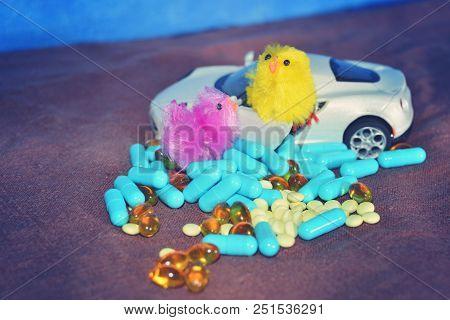 Children's White Typewriter Small Toys, Different Pills On A Brown Surface On A Blue Background. The