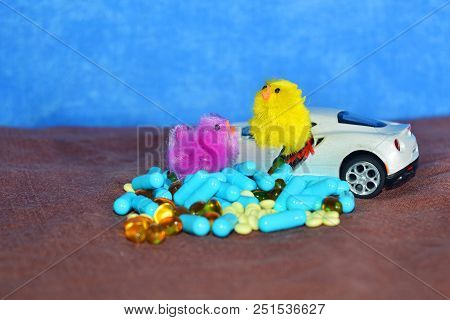 Children's White Typewriter Small Toys, Different Pills On A Brown Surface On A Blue Background. The