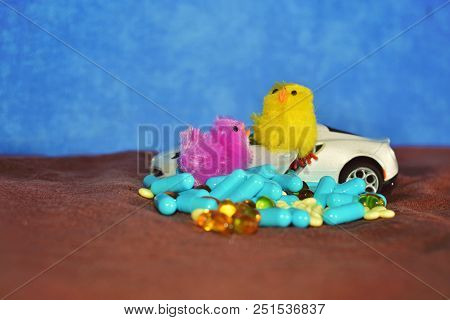 Children's White Typewriter Small Toys, Different Pills On A Brown Surface On A Blue Background. The