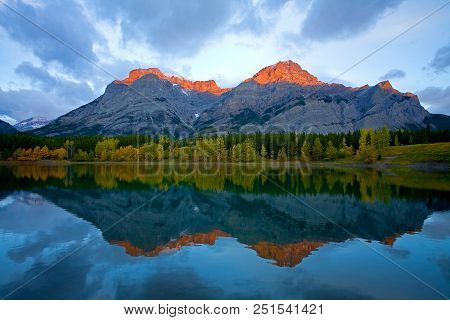 Alpenglow Appears On The Mountain Peaks Near Wedge Pond In Autumn