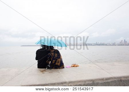 MUMBAI, INDIA - JULY 2 2018: Unidentified people visit promenade in South Mumbai. 
The promenade is an open space where people could meet friends and just spend time