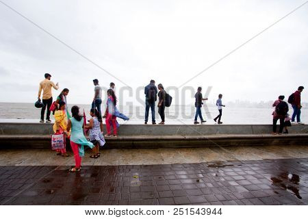 MUMBAI, INDIA - JULY 2 2018: Unidentified people visit promenade in South Mumbai. 
The promenade is an open space where people could meet friends and just spend time