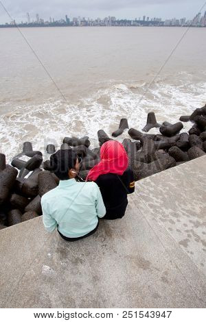 MUMBAI, INDIA - JULY 2 2018: Unidentified people visit promenade in South Mumbai. 
The promenade is an open space where people could meet friends and just spend time