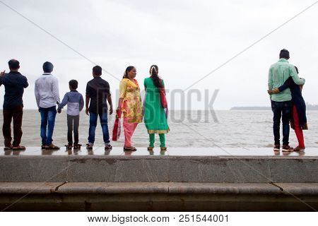 MUMBAI, INDIA - JULY 2 2018: Unidentified people visit promenade in South Mumbai. 
The promenade is an open space where people could meet friends and just spend time