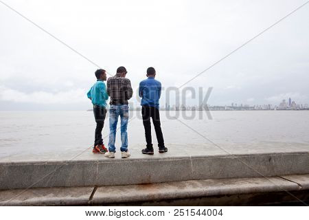 MUMBAI, INDIA - JULY 2 2018: Unidentified people visit promenade in South Mumbai. 
The promenade is an open space where people could meet friends and just spend time