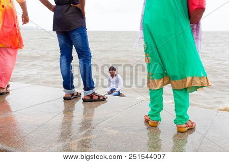 MUMBAI, INDIA - JULY 2 2018: Unidentified people visit promenade in South Mumbai. 
The promenade is an open space where people could meet friends and just spend time