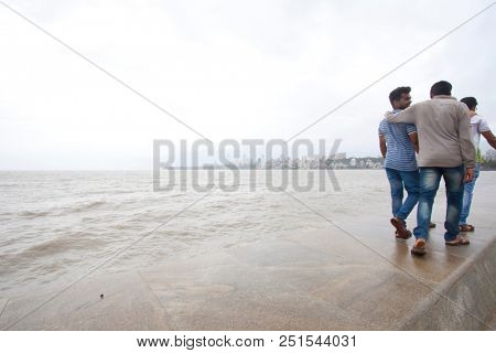 MUMBAI, INDIA - JULY 2 2018: Unidentified people visit promenade in South Mumbai. 
The promenade is an open space where people could meet friends and just spend time