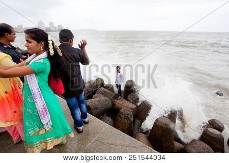 MUMBAI, INDIA - JULY 2 2018: Unidentified people visit promenade in South Mumbai. 
The promenade is an open space where people could meet friends and just spend time