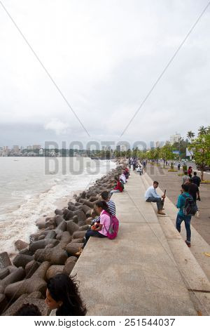MUMBAI, INDIA - JULY 2 2018: Unidentified people visit promenade in South Mumbai. 
The promenade is an open space where people could meet friends and just spend time