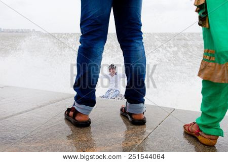 MUMBAI, INDIA - JULY 2 2018: Unidentified people visit promenade in South Mumbai. 
The promenade is an open space where people could meet friends and just spend time