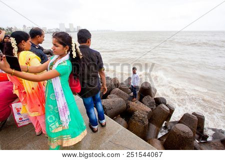 MUMBAI, INDIA - JULY 2 2018: Unidentified people visit promenade in South Mumbai. 
The promenade is an open space where people could meet friends and just spend time