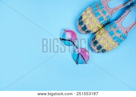 Summer Fashion Flatlay With Gradient Round Sunglasses And Espadrille Sandals On The Blue Background.
