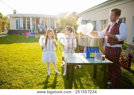 May 26, 2018. Moscow. Two Little Girls Eating White Sweet Cotton Candy. Kids With Candy Floss At The