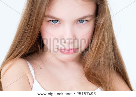 Emotion Face. Capricious Hurt Offended Child With Pursed Lips. Little Girl Portrait On White Backgro