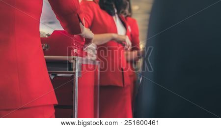 Flight Attendant Serving Food To Passenger On Aircraft. Stewardess Offer Drink On Board. Hostess Wit