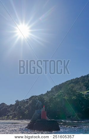 Mount Maunganui, New Zealand - July 30 2018; And Statue At Base Mounted On Rock In Water This Bronze