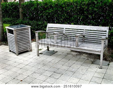 Wood Beanch With Wood Garbage Can Cover On A Public Street