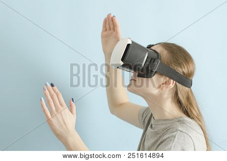 Yuong Woman With Glasses Of Virtual Reality. Blue Background
