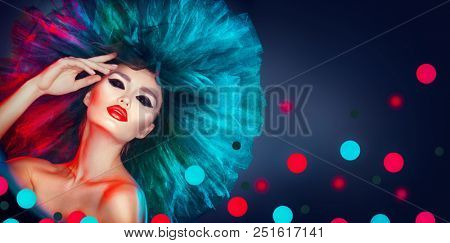 High Fashion model woman in colorful bright neon lights posing, portrait of beautiful sexy girl with trendy make-up and colourful hairdo. Art design, colorful make up. Vivid makeup. Night club dancer