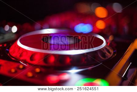 Bokeh Of Dj Turntable And Music Deck Illuminated At Night With Colourful Lights Lighting