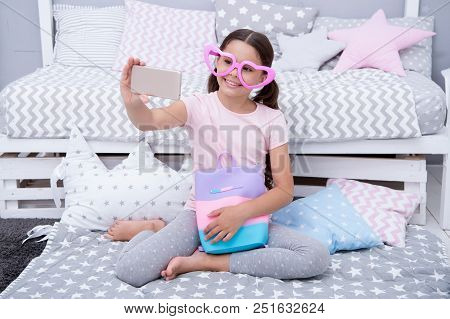 Cute Vlogger Streaming Video. Girl Child Sit On Bed In Her Bedroom And Taking Selfie Or Streaming Vi