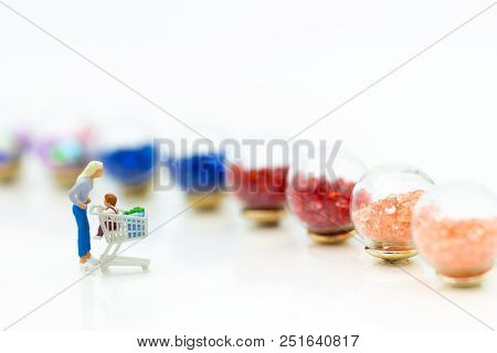 Miniature Person: Shopper Pushes A Shopping Cart. Image Use For Shopping ,marketing Place, Business 