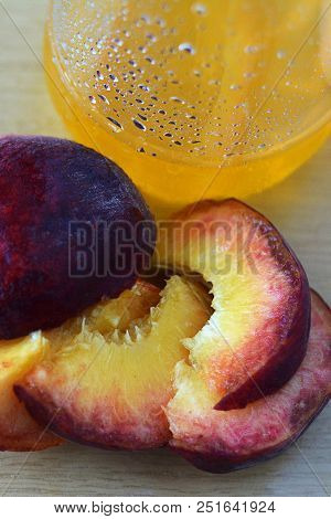 Juicy Peaches Of Peach And A Glass With Peach Juice. Vertical Orientation.