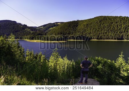 Tourist Looking Vidra Dam Lake In Parang Mountains