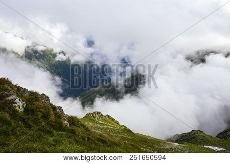 Summer Landscape With High Mountains And Clouds In A Summer Day
