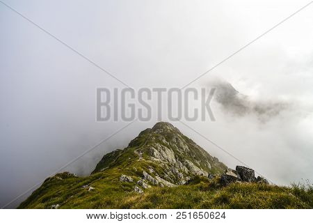 Summer Landscape With High Mountains And Clouds In A Summer Day