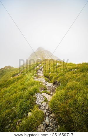 Summer Landscape With High Mountains And Clouds In A Summer Day