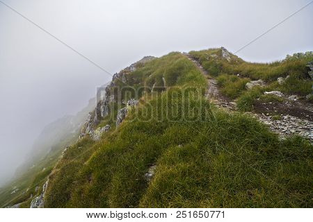 Summer Landscape With High Mountains And Clouds In A Summer Day