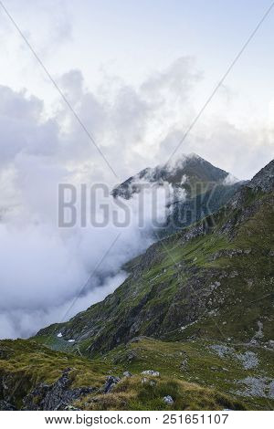 Summer Landscape With High Mountains And Clouds In A Summer Day
