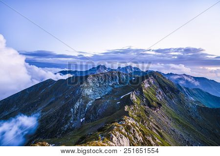 Summer Landscape With High Mountains And Clouds In A Summer Day