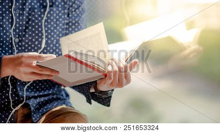Reflection Of Male Body Reading Book In Public Library. Self Learning And Education Concept