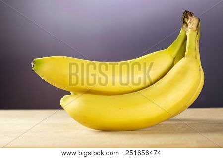 Group Of Five Whole Fresh Yellow Banana One Cluster With Grey Gradient Behind