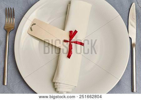 Empty White Plate With Nupkin On A Gray Background
