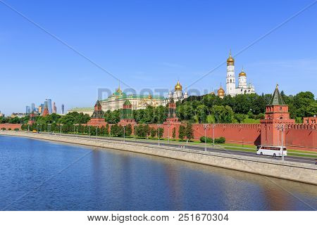 Moscow Kremlin And Kremlevskaya Embankment On A Blue Sky Background In Sunny Summer Morning