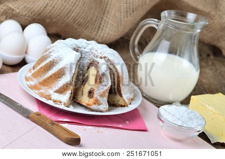 Sliced Homemade Lemon Marble Cake Sprinkled With Sugar, Milk, Eggs, Melissa Leaves, And Butter, Stil