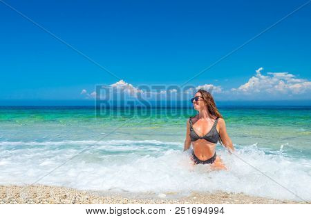 woman sunbathing on the beach summer travel holidays