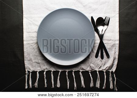 Top View Of A Restaurant Table With Plate, Knife, Fork And A Napkin In Luxurious Restaurant
