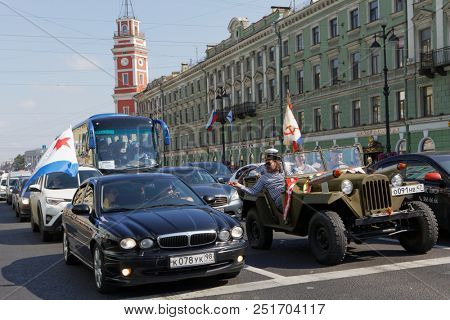 ST. PETERSBURG, RUSSIA - JULY 29, 2018. People worn in telnyashka, the iconic uniform garment of Russian Navy, in military car on Nevsky avenue during Navy Day celebrations